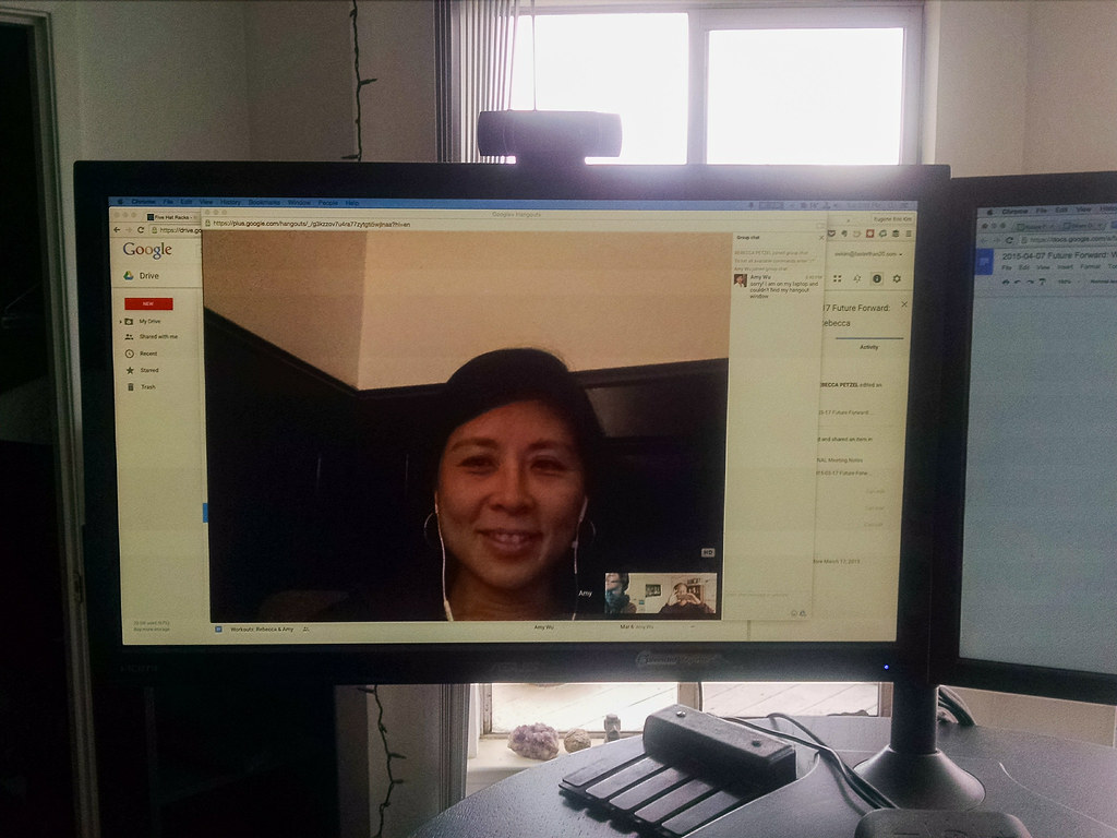 Two people on a video call discussing a project on a laptop