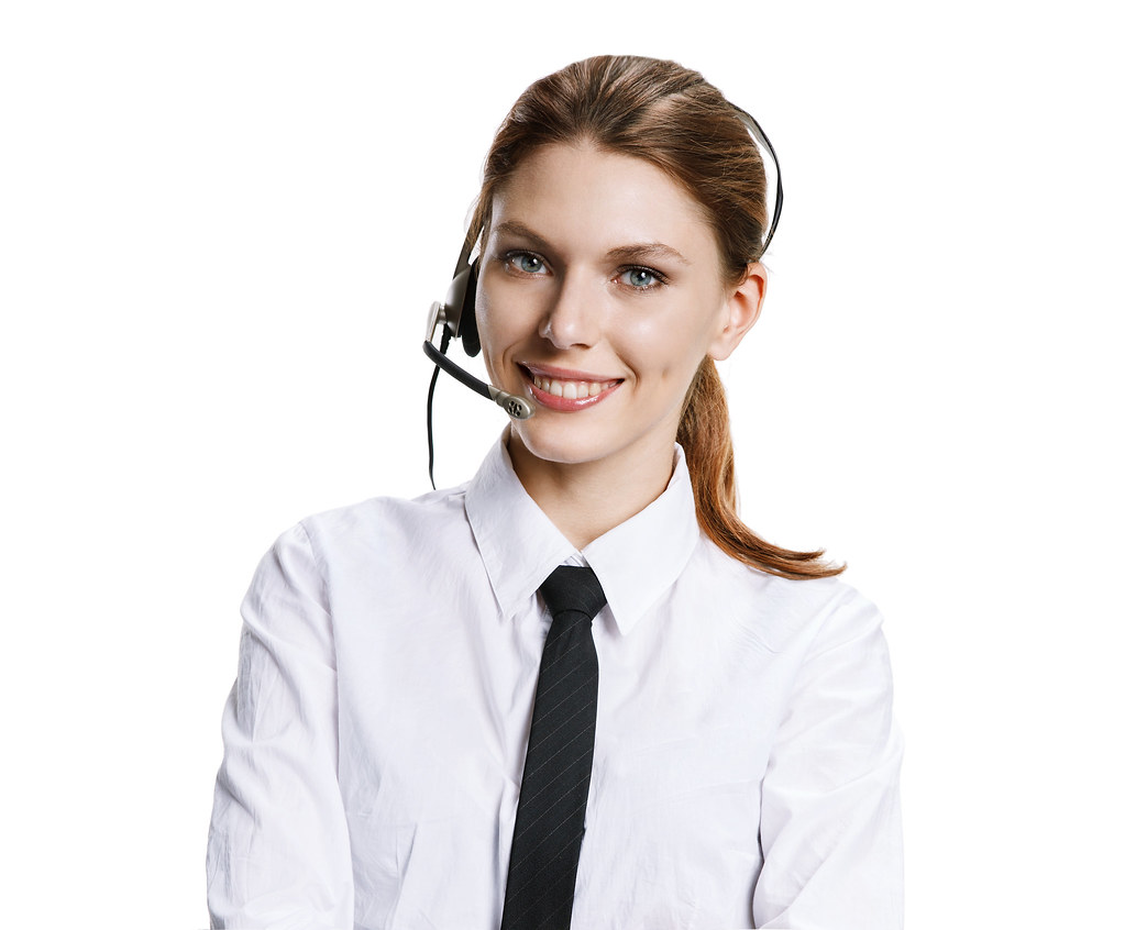 A customer service agent wearing a headset at a computer