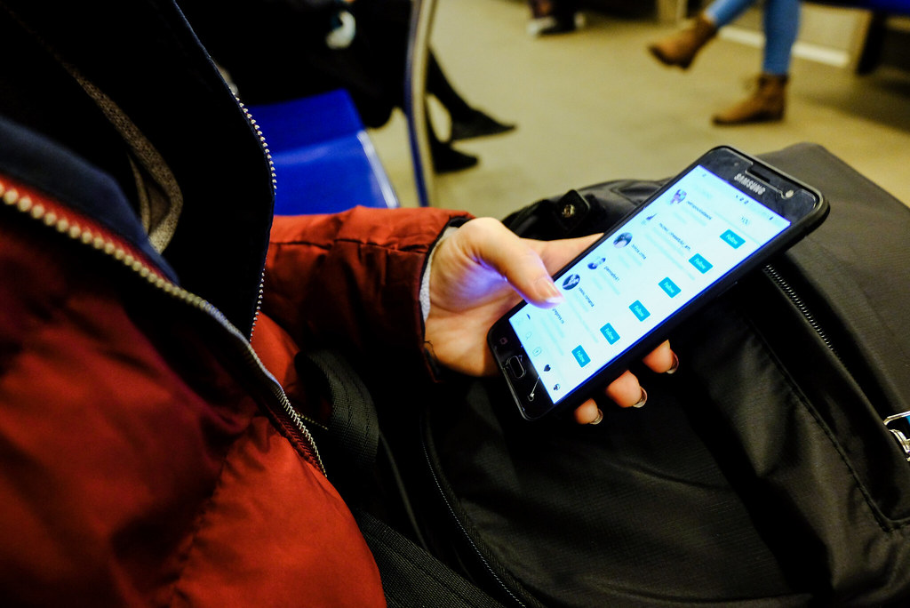 Person scrolling social media feed on a phone