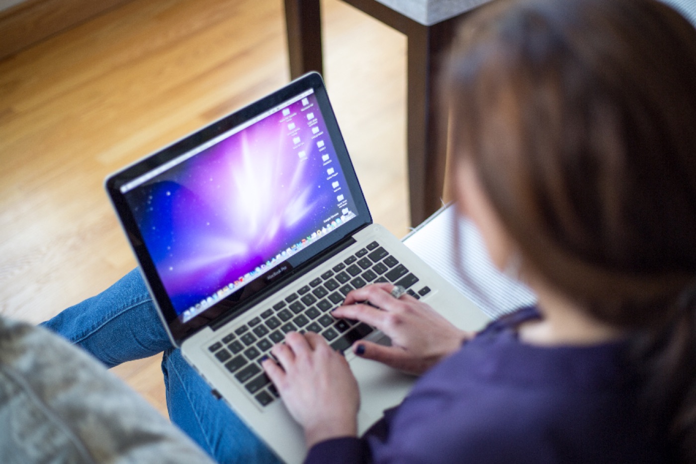 A person typing on a laptop