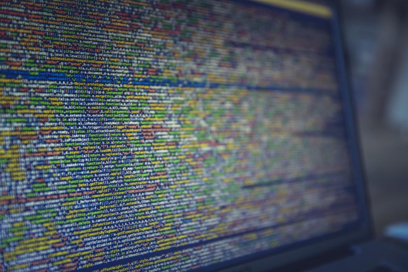 A monitor densely filled with colourful code